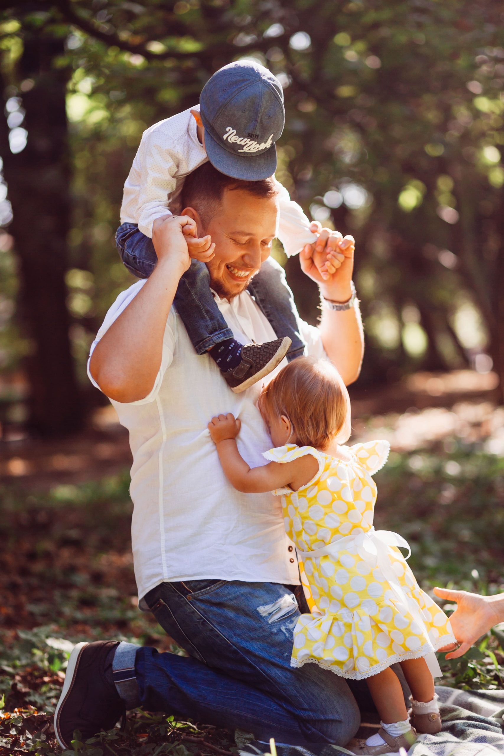 father-plays-with-his-son-daughter-green-lawn-park-1-1-scaled.jpg