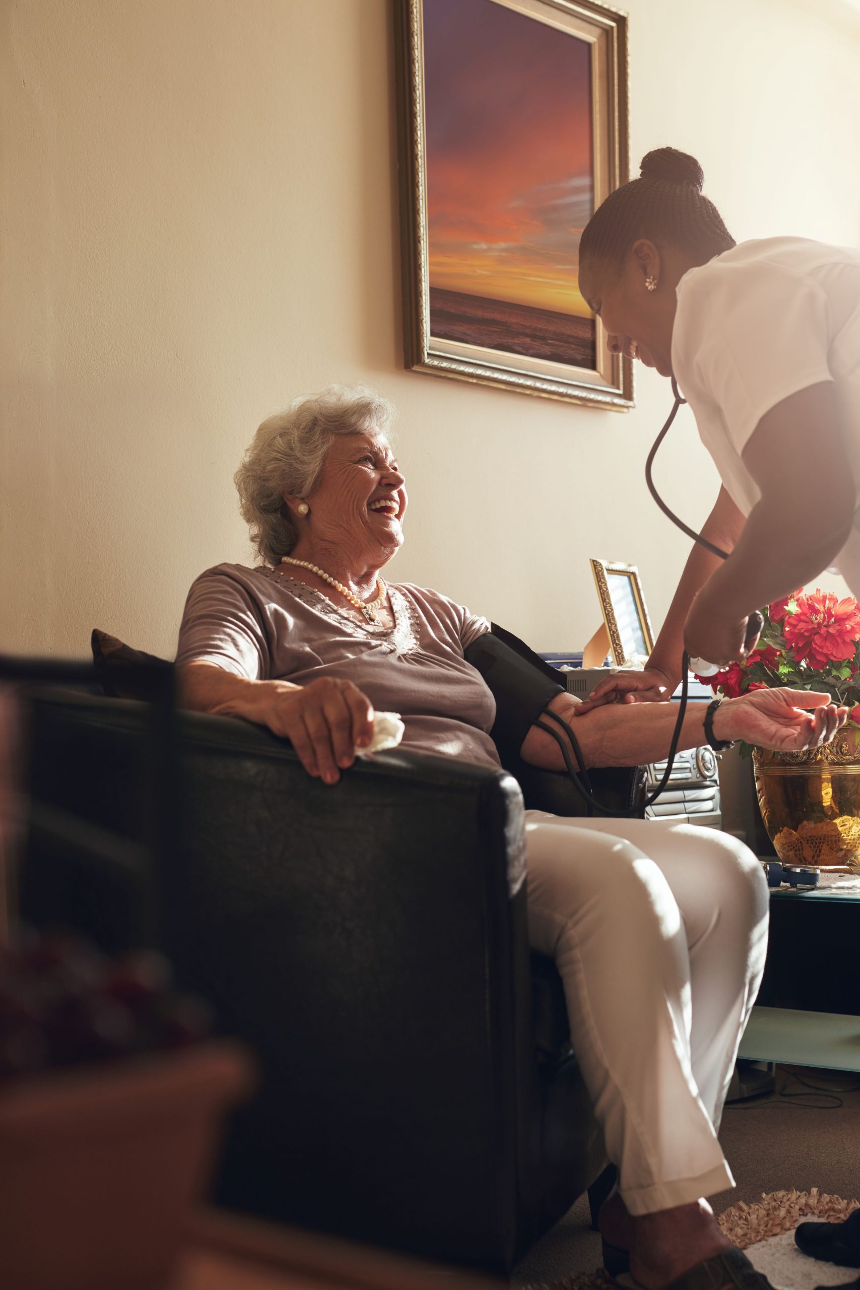 home-caregiver-measuring-blood-pressure-senior-patient-home-female-healthcare-worker-doing-routine-checkup-elderly-patient-2-scaled.jpg