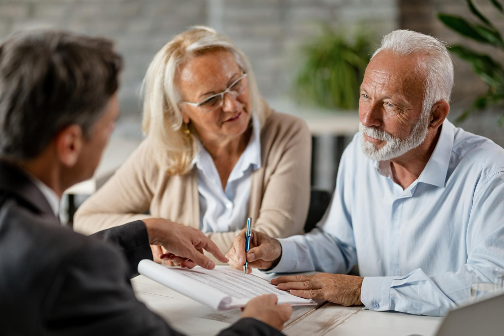 mature-couple-having-meeting-with-bank-manager-signing-lease-agreement-office-focus-is-mature-man.jpg