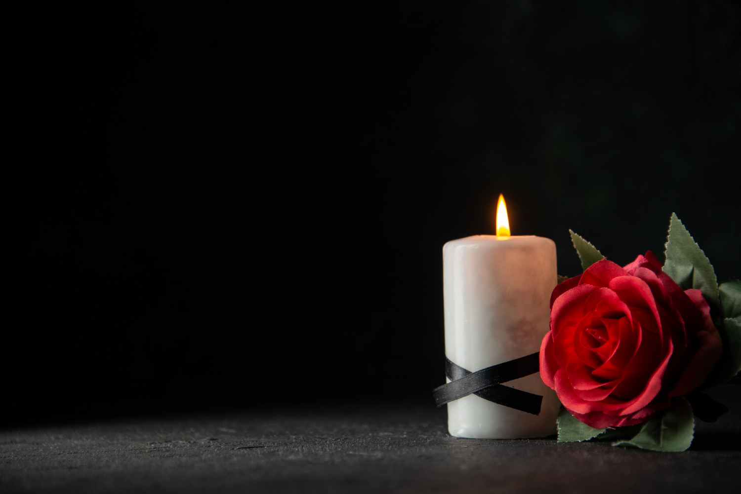 front-view-white-candles-with-red-flower-dark-wall.jpg