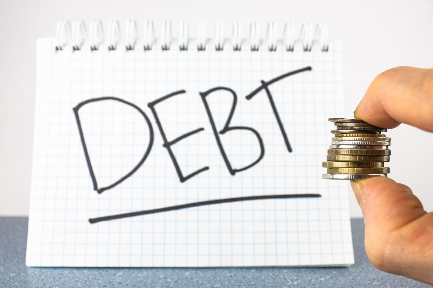 word-debt-notepad-coins-concept-debt-collection-payment-debts.jpg