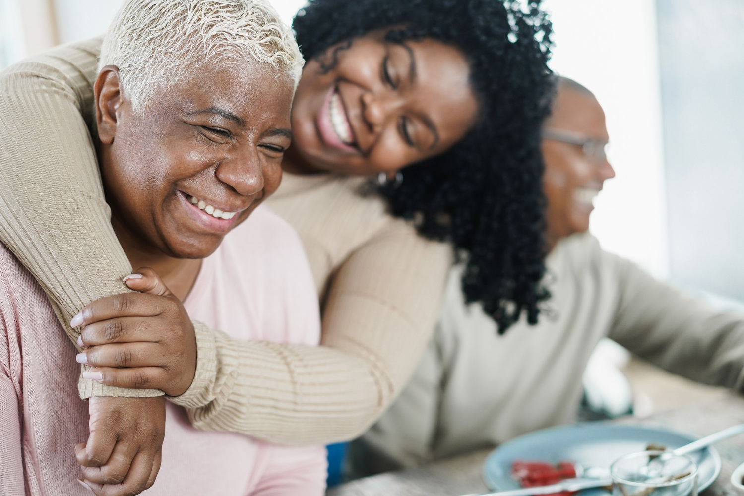 african-daughter-hugging-her-mum-during-lunch-meal-home-love-family-concept-main-focus-senior-woman-face.jpg