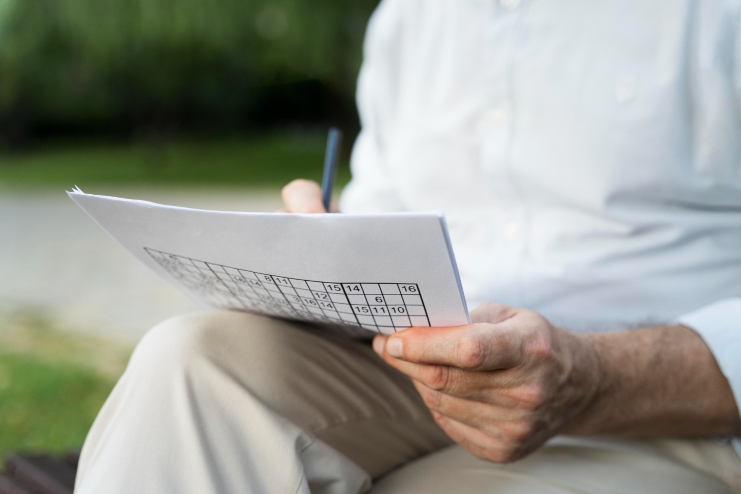 man-enjoying-sudoku-game-paper-by-himself.jpg