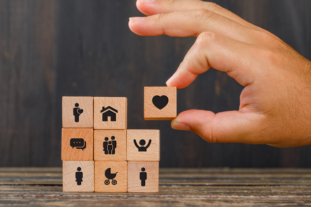 relationship-concept-wooden-table-side-view-hand-holding-wooden-cube-with-heart-icon-1.jpg